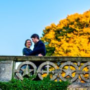 Couple by a stone wall in the sunlight