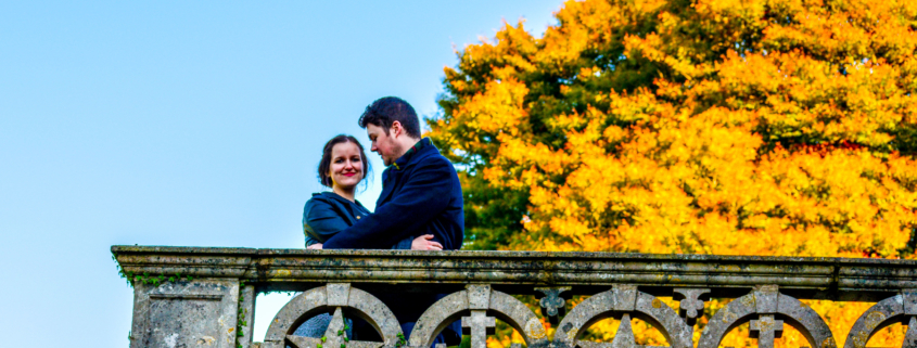 Couple by a stone wall in the sunlight